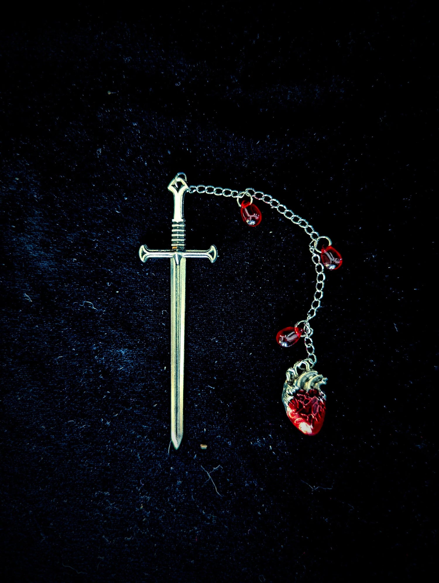 sword shaped bookmark with anatomical heart pendant 