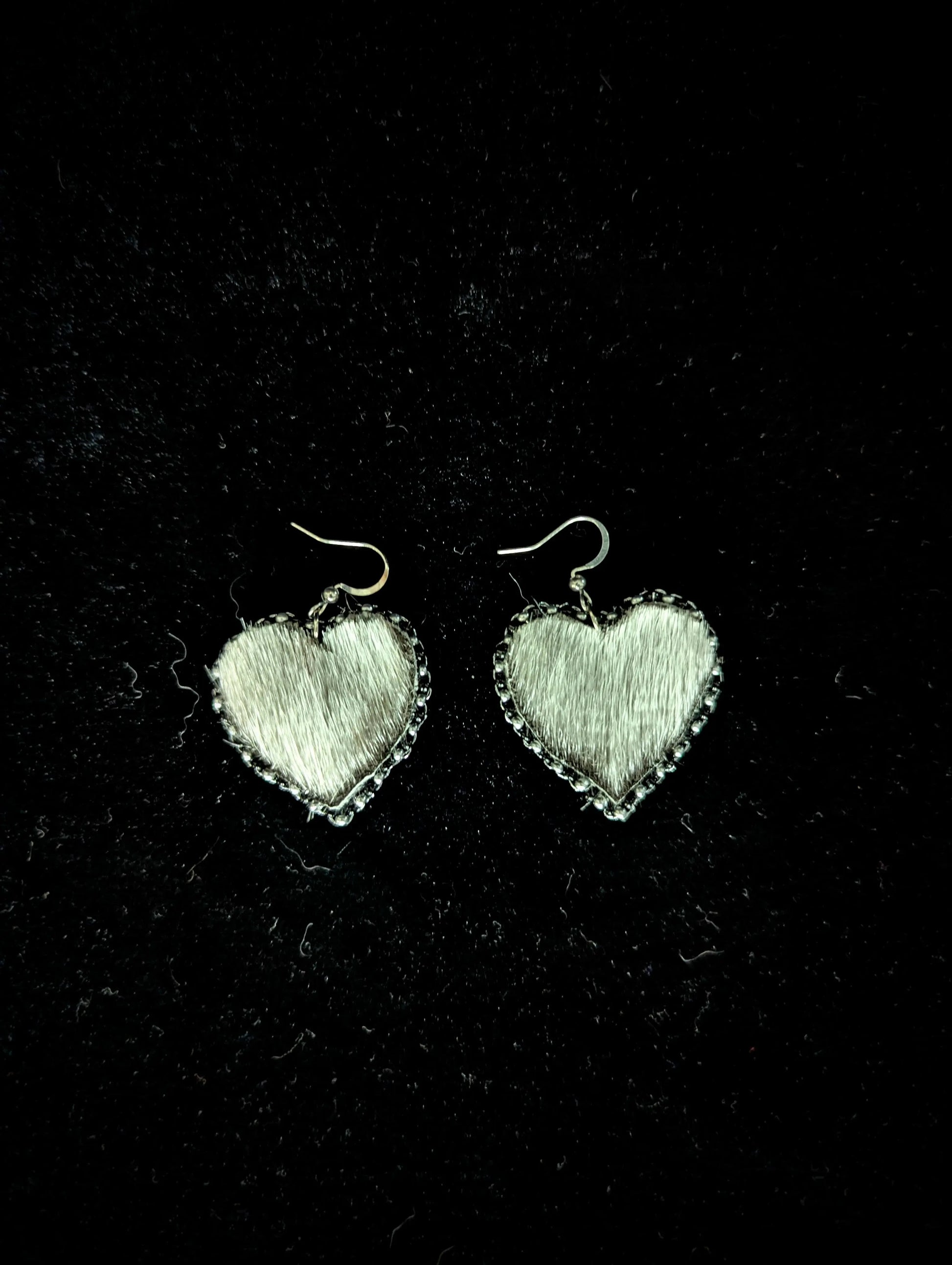 Heart-shaped earrings on a black background
